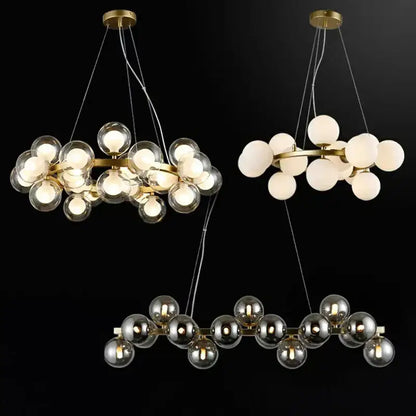 Gold-toned DecorBites LED pendant light chandelier with spherical glass bulbs in clear frosted white and mirrored finishes