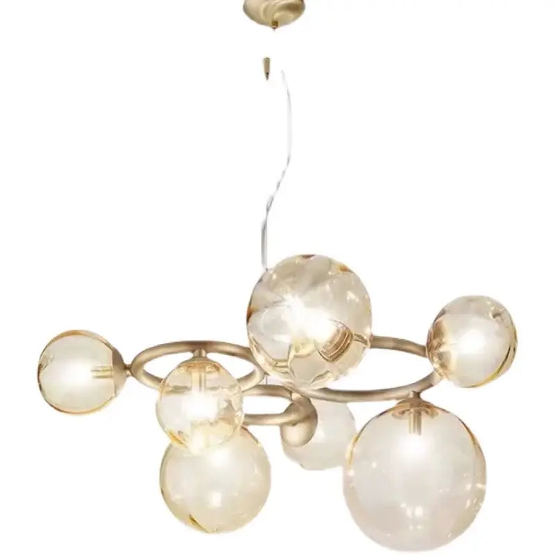 A modern DecorBites LED pendant light chandelier with amber glass spheres on a brass frame for indoor lighting