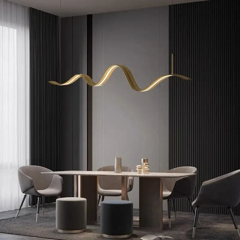A sleek golden wave-shaped DecorBites led pendant light hangs above the dining table for modern decor