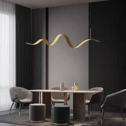 A sleek golden wave-shaped DecorBites led pendant light hangs above the dining table for modern decor