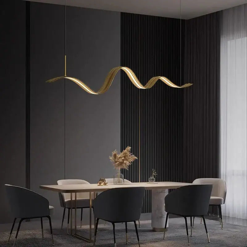 Golden wave-shaped DecorBites LED pendant light with sleek metallic finish hangs above dining table for modern decor