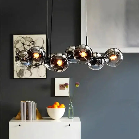 Modern glass globe pendant lights with sleek black metal frame and warm bulbs for indoor living and dining by decorbites led pendant