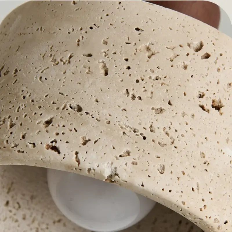Beige porous stone bowl pendant light fixture with textured yellow travertine and modern wood canopy by DecorBites