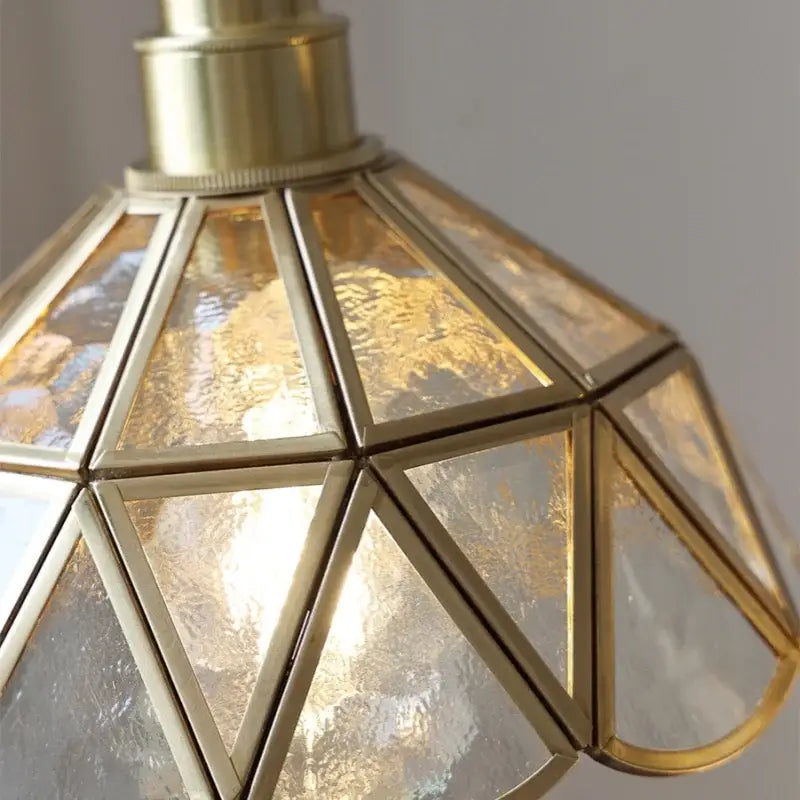 A brass-framed decorbites led pendant light with amber textured glass panels for living and dining rooms