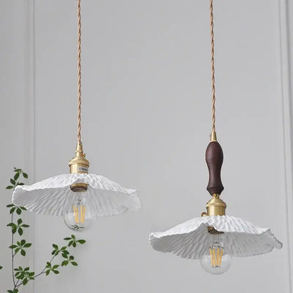Two elegant white ceramic pendant lights with gold-toned hardware and twisted copper cords by DecorBites LED pendant light fixture