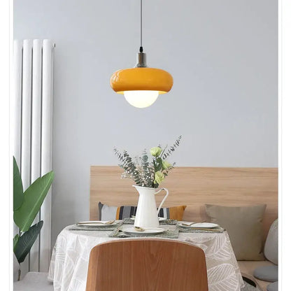 Vibrant yellow DecorBites™ LED pendant light with glossy rounded glass shade and metallic fixture for modern rooms
