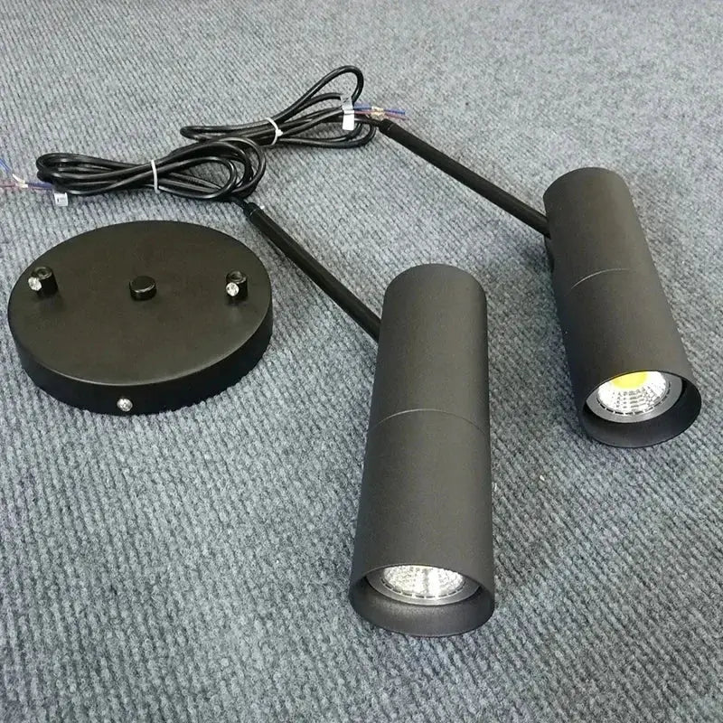 Black cylindrical led pendant light by decorbites with matte finish and adjustable arms for bedroom and dining room use