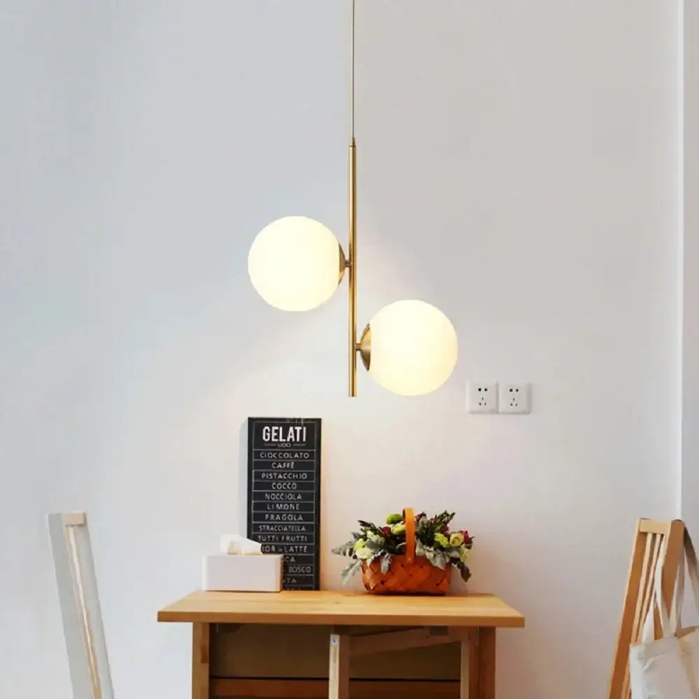 Modern brass DecorBites LED pendant light with two frosted glass spherical shades for home decor lighting