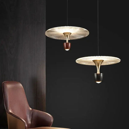 Two modern decorbites led pendant lights with gold metal frames and textured glass shades for bedroom and dining room
