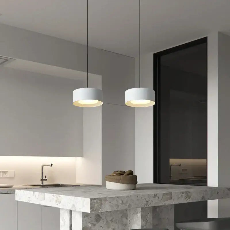 Two minimalist white cylindrical decorbites led pendant lights with matte finish and warm glow for living spaces