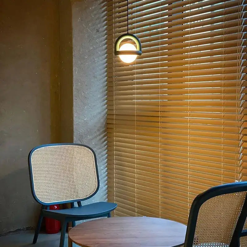 DecorBites led pendant lights with a sleek black metal frame and circular glass shade emitting warm glow for dining room