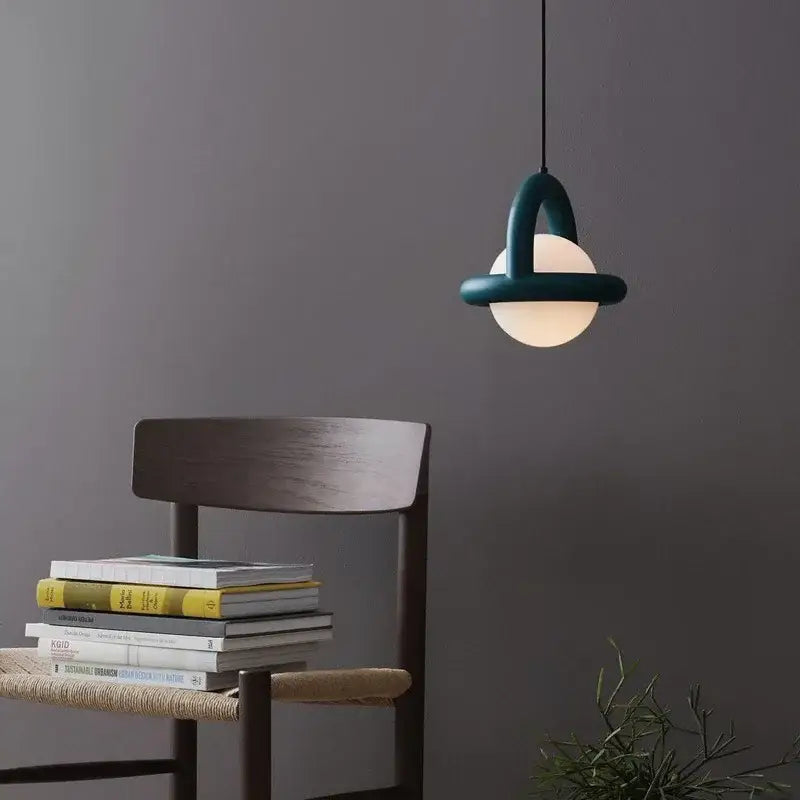 Teal decorbites led pendant light with arched metal frame and frosted glass globe for dining room and kitchen use