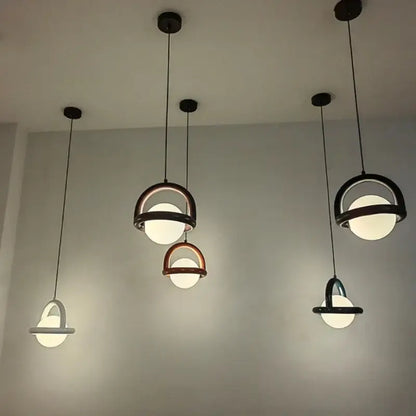 Modern DecorBites LED pendant lights with black and copper metal frames and acrylic ball bulbs for dining room