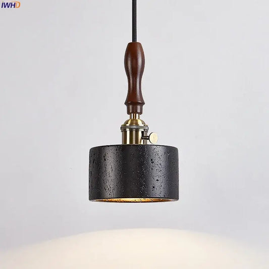 Black textured cylindrical pendant light with brass fixture and dark wood handle by decorbites led pendant light black travertine