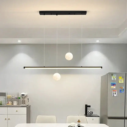 Modern black linear DecorBites LED pendant lights featuring two white globe fixtures for dining room and kitchen lighting