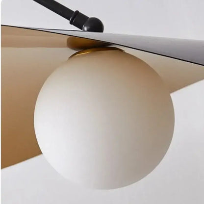 Cream-colored frosted glass globe pendant light with black metal arm and gold hardware from decorbites led pendant lights