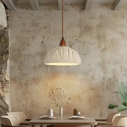 A textured off-white decorbites led pendant light with wooden stem hangs above the dining table in modern decor
