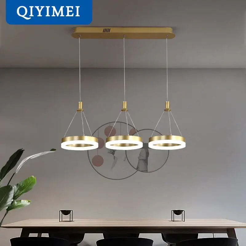 Gold-toned DecorBites led pendant lights with three circular rings suspended from a rectangular ceiling mount