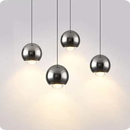 Set of four sleek brushed chrome spherical decorbites led pendant lights with warm led illumination for modern interiors