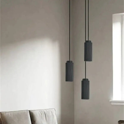 Three sleek dark gray cylindrical decorbites led pendant lights with vertical ridges for bedroom and kitchen use