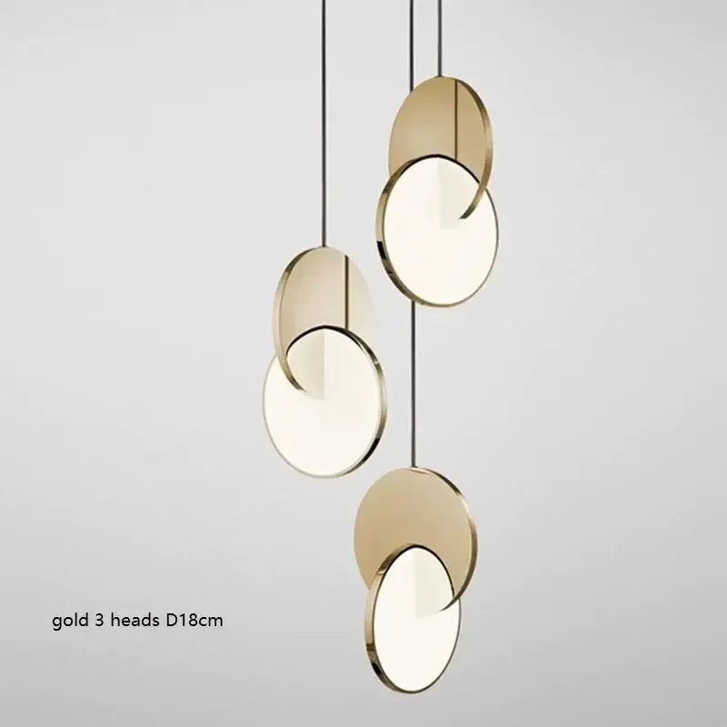 Modern gold-toned decorbites led pendant light with three overlapping circular heads and frosted glass centers