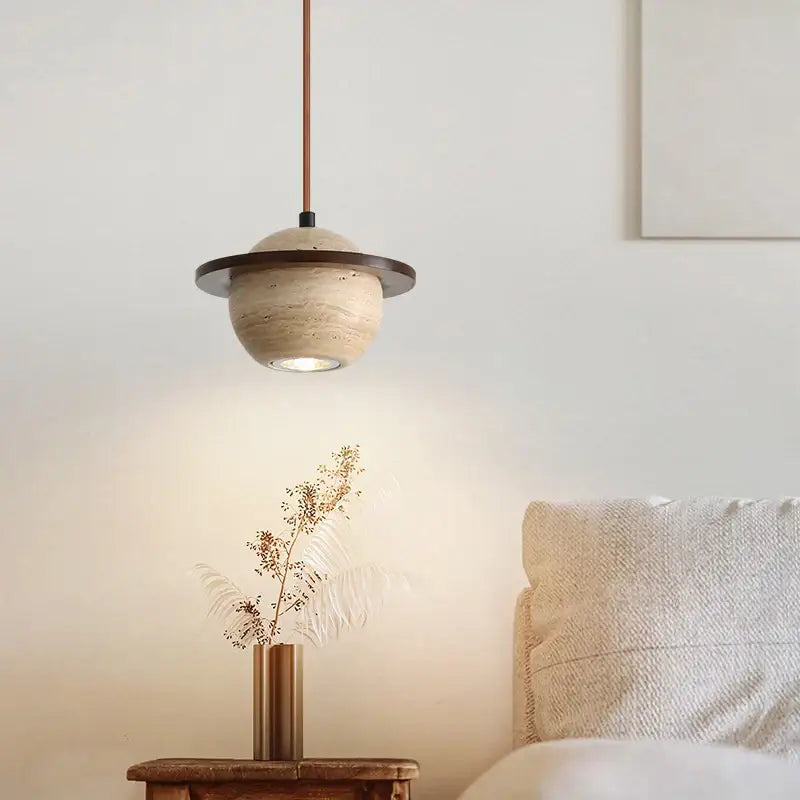 A modern DecorBites LED pendant light with a beige textured stone globe and dark bronze ring accent