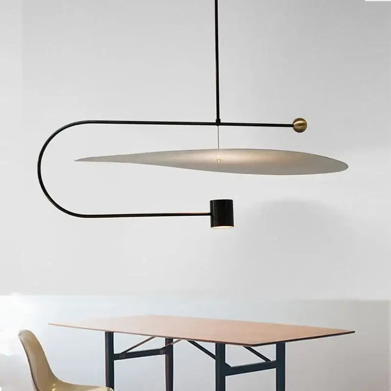 Modern black and brass decorbites led pendant light fixture with curved metal frame and oval diffuser for dining room