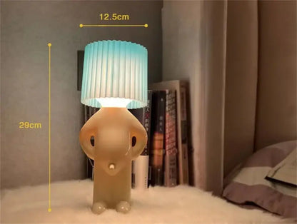 A charming beige elephant-shaped decorbites led pleats table lamp with a pleated gradient blue and white shade for reading
