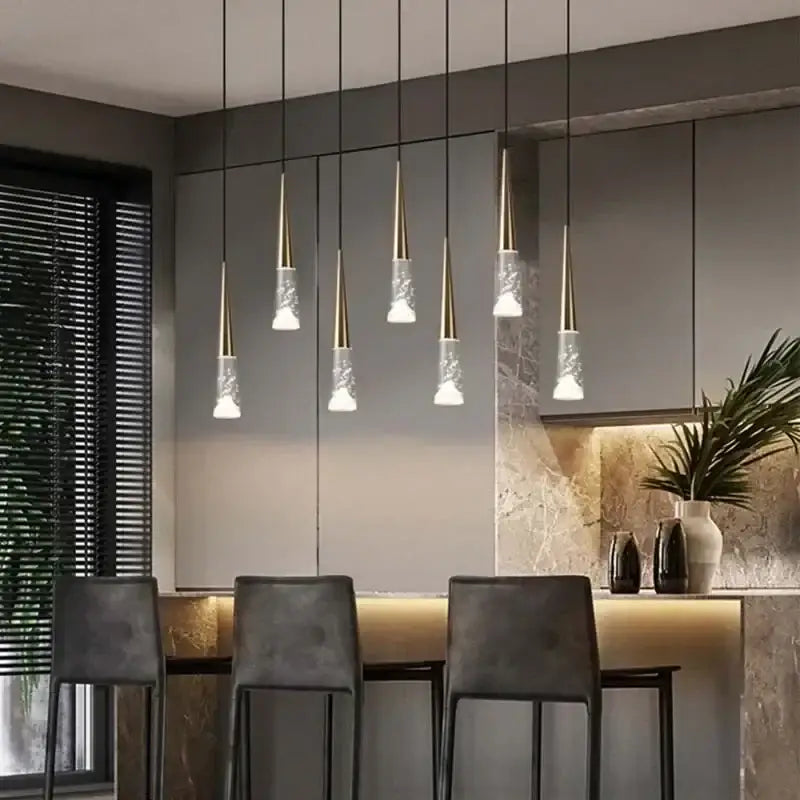 Modern nordic decorbites led rain drop chandelier with gold metal tops and textured glass shades above kitchen island
