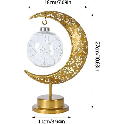 Golden crescent moon-shaped table lamp with intricate cut-out patterns and clear glass globe with wire lights decorbites led ramadan