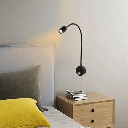 Black gooseneck decorbites led reading light with flexible arm and dimmable switch mounted beside wooden nightstand