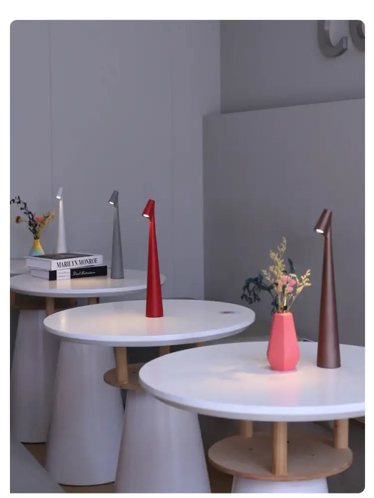 Red conical metallic decorative table lamp with integrated led rechargeable desk light and touch dimming feature