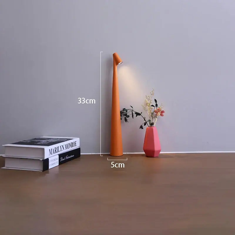 Orange tapered decorbites™ led rechargeable desk lamp with sleek design emitting warm light for table lamp use