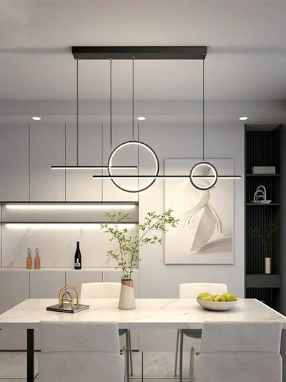 Modern black minimalist decorbites led restaurant chandelier with circular linear led elements above white marble dining table