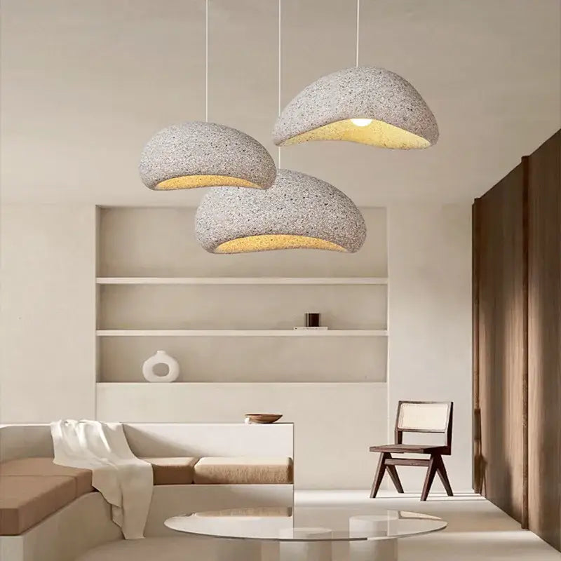 Three decorbites led restaurant pendant lights with speckled gray exterior and warm yellow interior for home and cafe decor