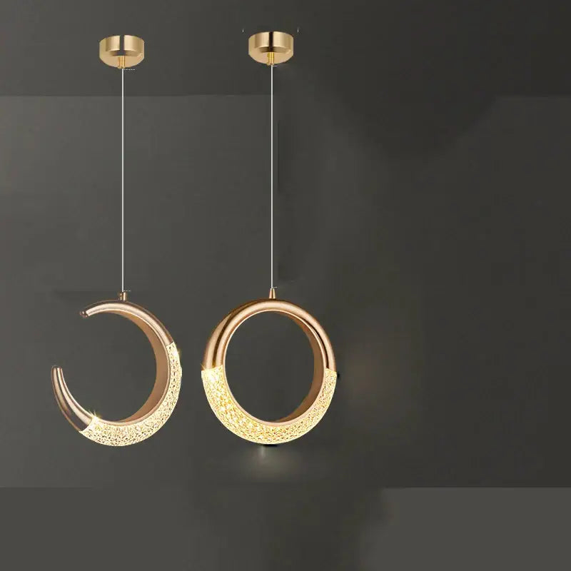 Two modern gold-toned pendant lights from decorbites™ led ring and moon lamps set with textured illuminated surfaces