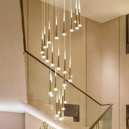 Modern gold-toned decorbites led ring chandelier with slender tapered pendants in a cascading indoor lighting design