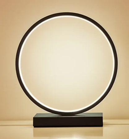 Decorbites™ led ring table lamp with sleek black frame and glowing white light on matching rectangular base for modern lighting