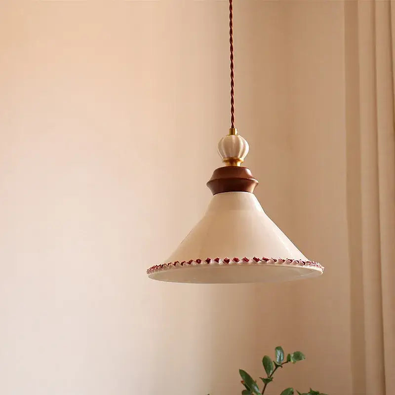 Cream-colored ceramic led rose flower pendant lamp with wooden collar and red beaded trim for modern decor