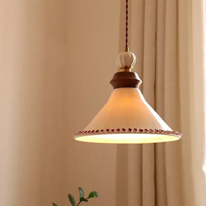 Cream-colored ceramic led rose flower pendant lamp with dark wood accent and decorative red bead trim by DecorBites™