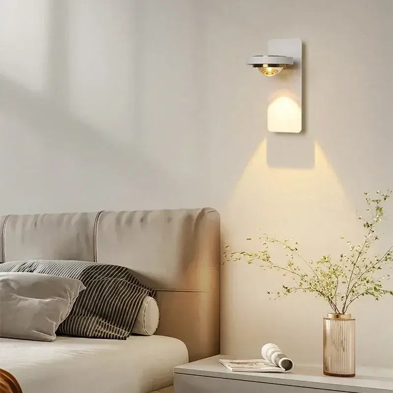 Decorbites led rotatable wall lamp with white rectangular backplate and chrome accents emitting warm light