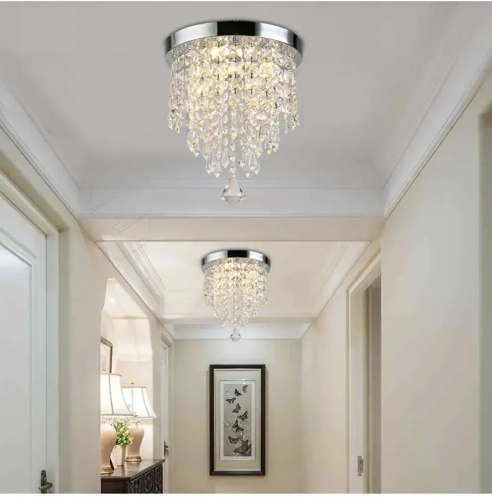 Chrome-finished crystal chandelier with cascading glass prisms and polished metal base for decorbites led round ceiling light