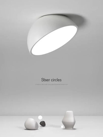 A sleek modern white decorbites led semicircular ceiling light with a smooth curved dome design for bedroom use