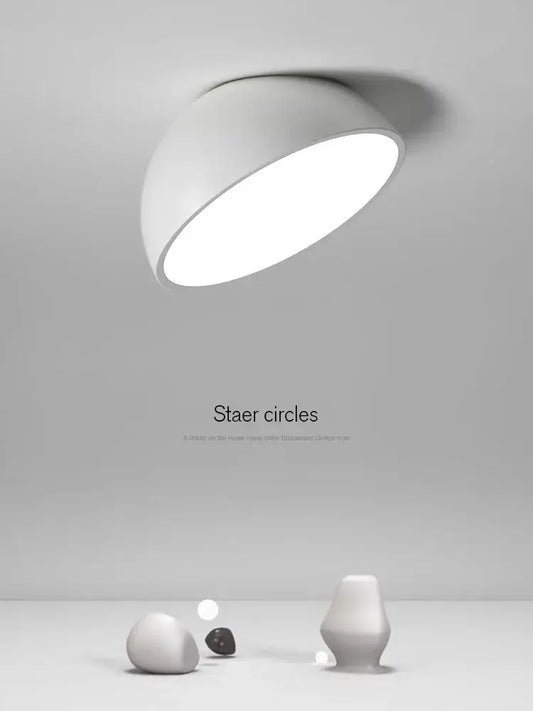A sleek modern white decorbites led semicircular ceiling light with a smooth curved dome design for bedroom use