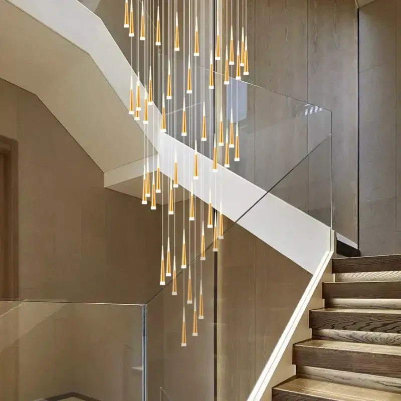 Modern gold-toned decorbites led spiral chandelier with slender cone-shaped lights for stairwell lighting