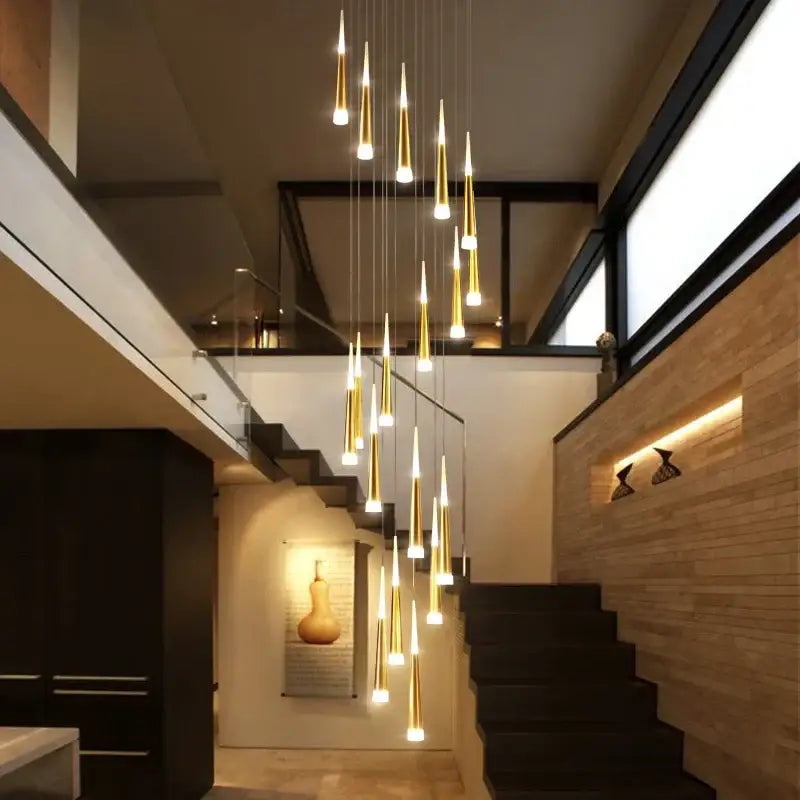 A modern decorbites led spiral chandelier featuring gold-toned pendant lights with tapered glass shades for stairwell lighting