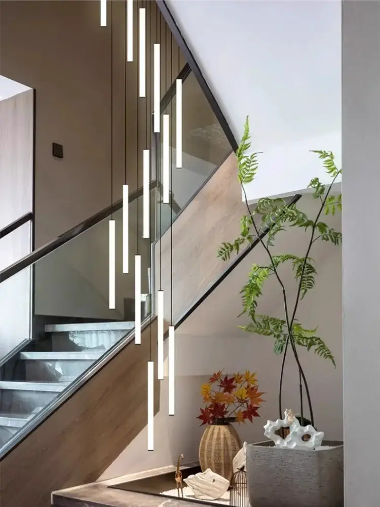 Modern white cylindrical led spiral staircase chandelier with pendant lights arranged staggeredly for home decoration