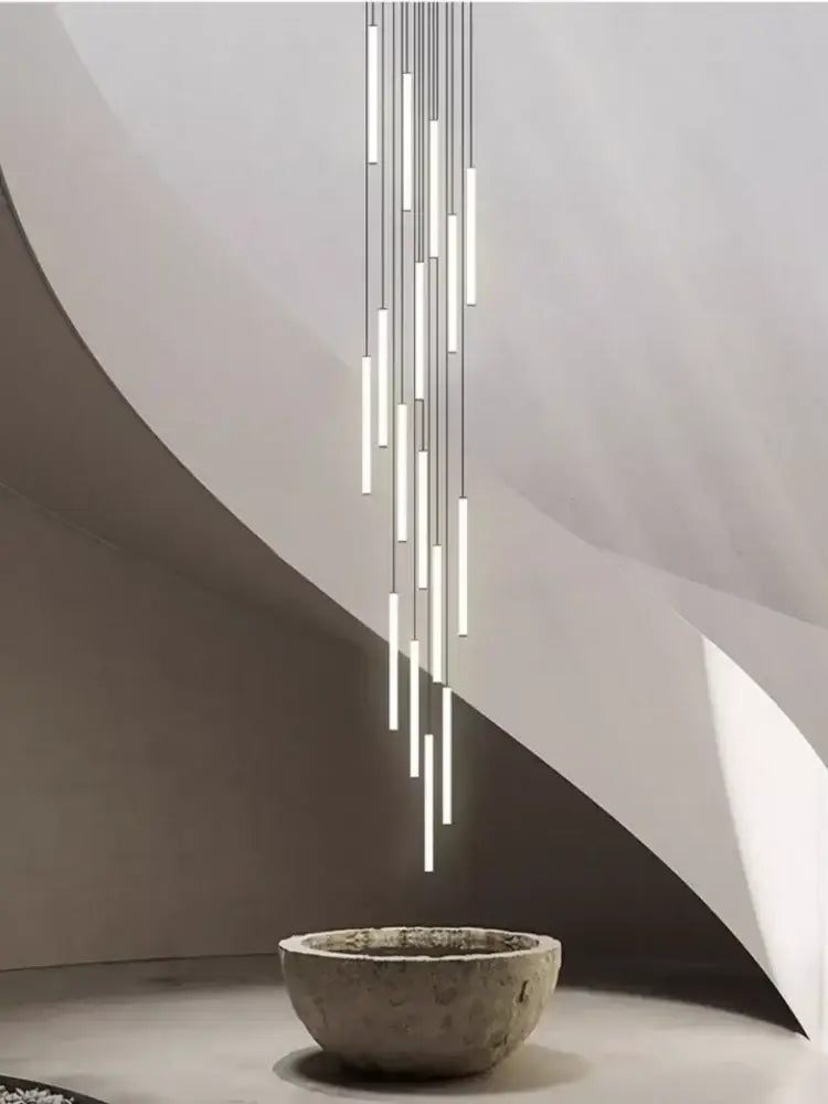 A modern minimalist decorbites™ led spiral staircase chandelier with slender cylindrical tubes for home lighting