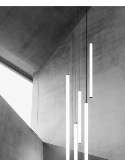 Modern minimalist decorbites™ led spiral staircase chandelier with sleek cylindrical pendant lights and thin black cords