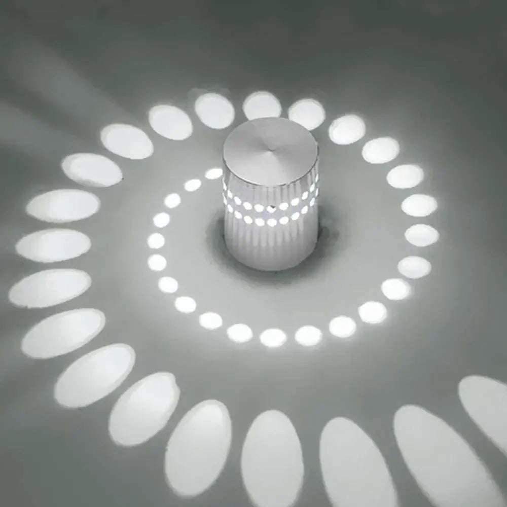 A sleek cylindrical silver decorbites led spiral wall light with textured surface casting elegant spiral glow